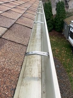 top view of shingled roof with cleaned gutter